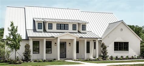 metal roof on brick ranch house|white farmhouse with metal roof.